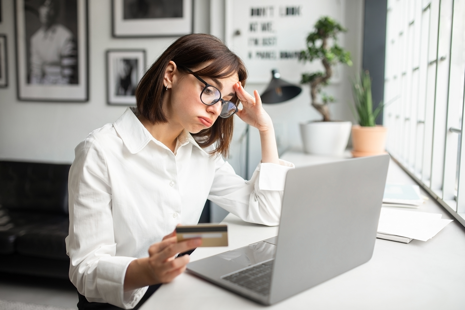 Stressed woman ordering online, showing the challenges of managing group apparel orders without a system