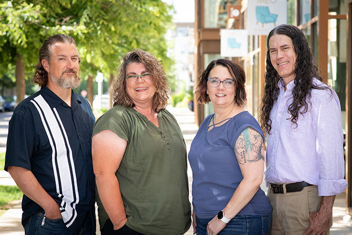 The Zamar Printing team standing together outdoors, representing their friendly service, decades of experience, and dedication to customers since 1993.